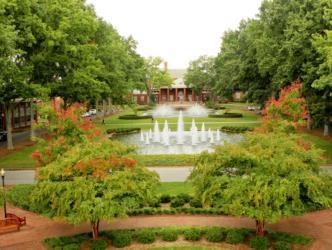 lush campus quad with fountains and trees