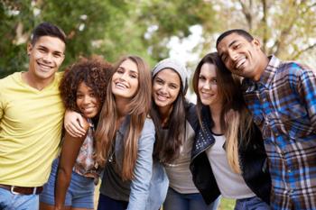 group of happy students smiling outdoors