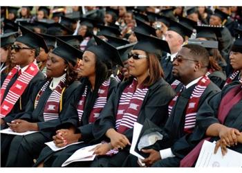 graduates at ceremony in caps and gowns