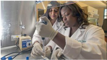 two scientists pipetting in a lab