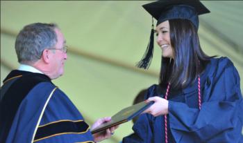 graduate receiving diploma at ceremony