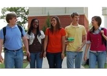 group of students walking and talking on campus