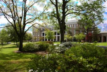 lush campus greenery in front of a building