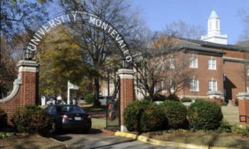 arched entrance sign reading 'university montevallo' with building behind