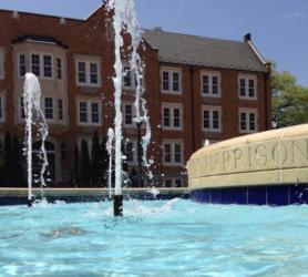 fountain in front of brick building with 'jeppison' text