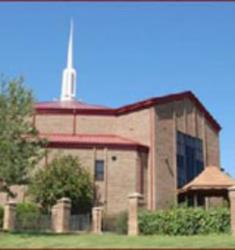 red-roofed building with steeple under blue sky