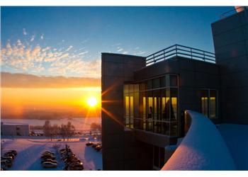 sunset over snowy campus buildings