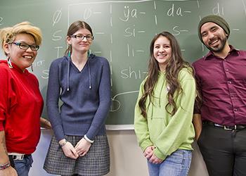 students and teacher by chalkboard