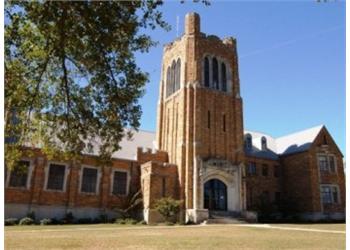 historic brick building with tower under blue sky