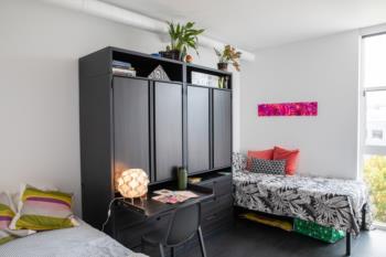 dorm room with modern decor and natural light