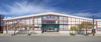 modern building with red accents under blue sky