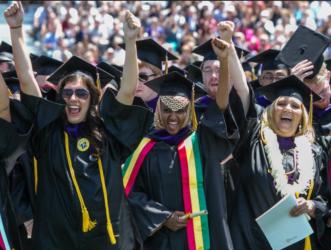 graduates smiling during commencement