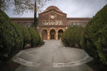 symmetrical view of a brick building with arched entrances