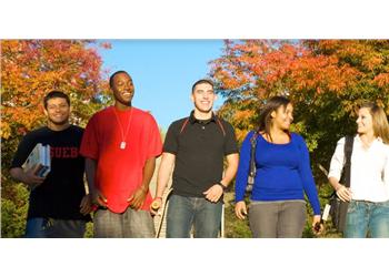 group of smiling students with autumn trees