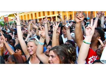 crowd of students with upraised hands at an event
