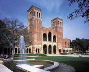 brick building with towers and fountain