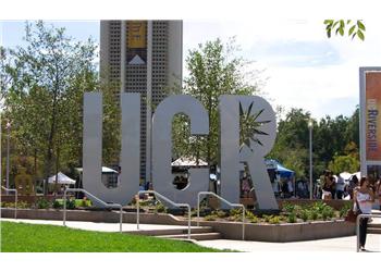 large 'ucr' letters with buildings in background