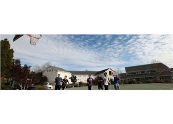 students playing basketball outdoors