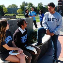 students wearing 'cerritos' shirts talking outdoors