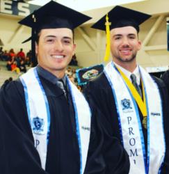 two graduates in regalia with 'cerro coso' sashes