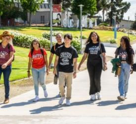 students walking on campus wearing school t-shirts