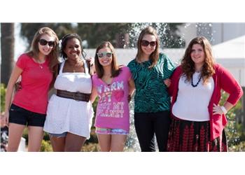 five students posing outdoors