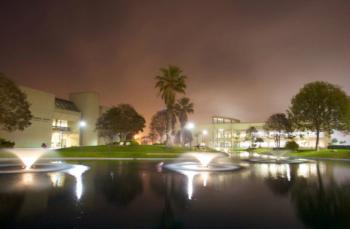 night view of campus building with fountains