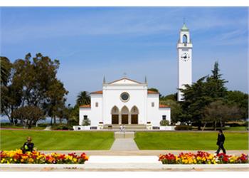 campus building with bell tower and people