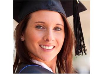 smiling graduate in cap and gown