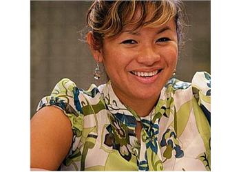 smiling woman in patterned blouse