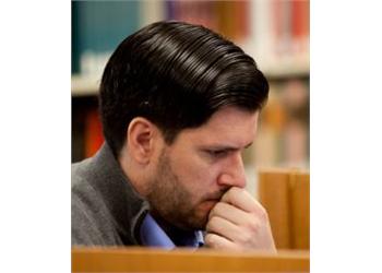 focused man reading in a library