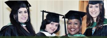 graduates smiling in caps and gowns