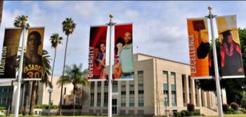 college banners outside building with clear skies