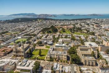 aerial view of campus with city and ocean in background