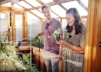 students smiling in a greenhouse