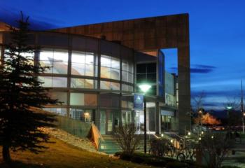 modern building facade at night with interior lights on