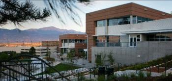 panoramic view of university buildings and mountains at sunset