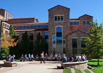 outdoor classroom session with students seated in a circle