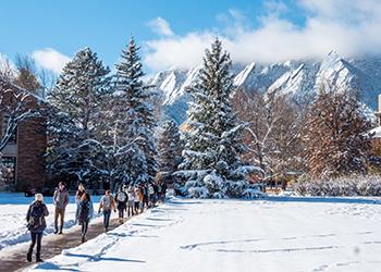 snow-covered campus walkway with mountainous background