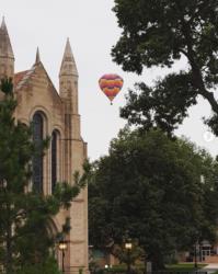 gothic style building with hot air balloon in sky