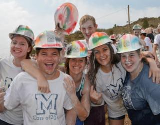 group of students in painted hard hats