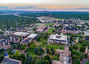 aerial view of college campus with city skyline