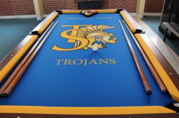 pool table with 'TROJANS' logo