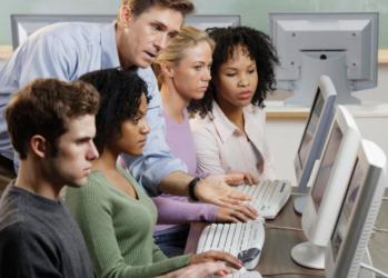 students and teacher at computers