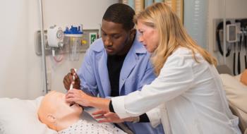 nursing student and professor with mannequin