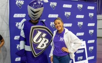 mascot with student at university event