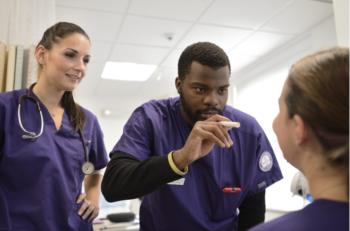 nursing students practicing in lab setting