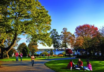 students walking on a campus with lake view