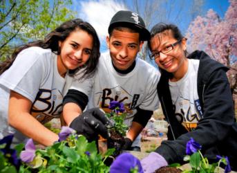 students gardening with 'Big Event' shirts