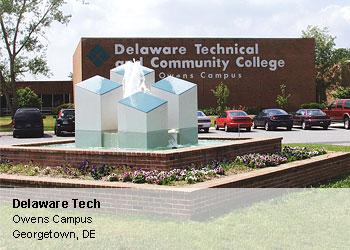 sculpture in front of building with Delaware Tech sign